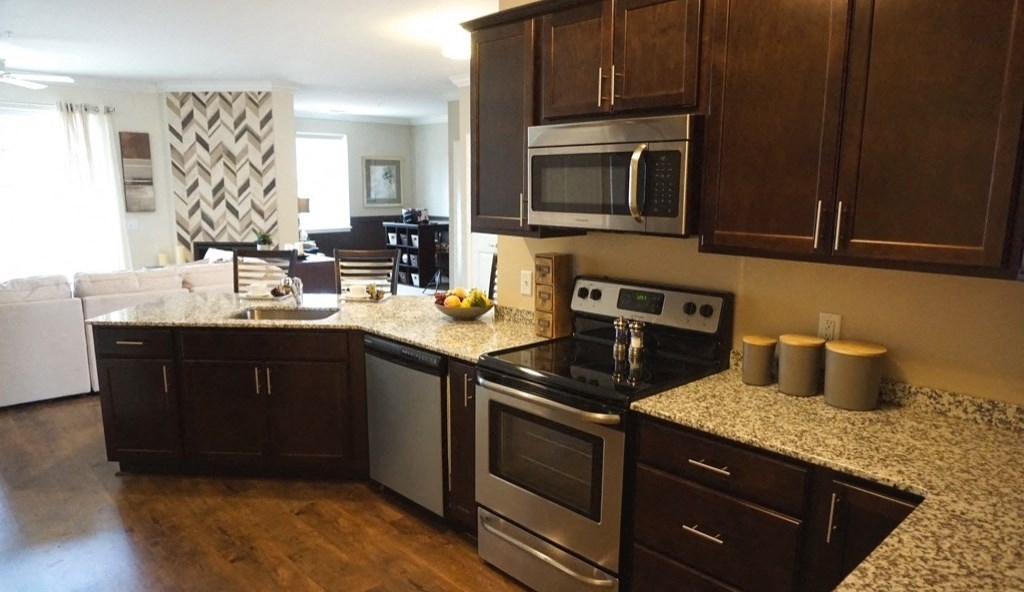 a kitchen with stainless steel appliances and granite counter tops