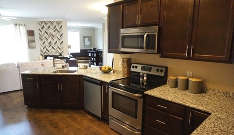a kitchen with stainless steel appliances and granite counter tops