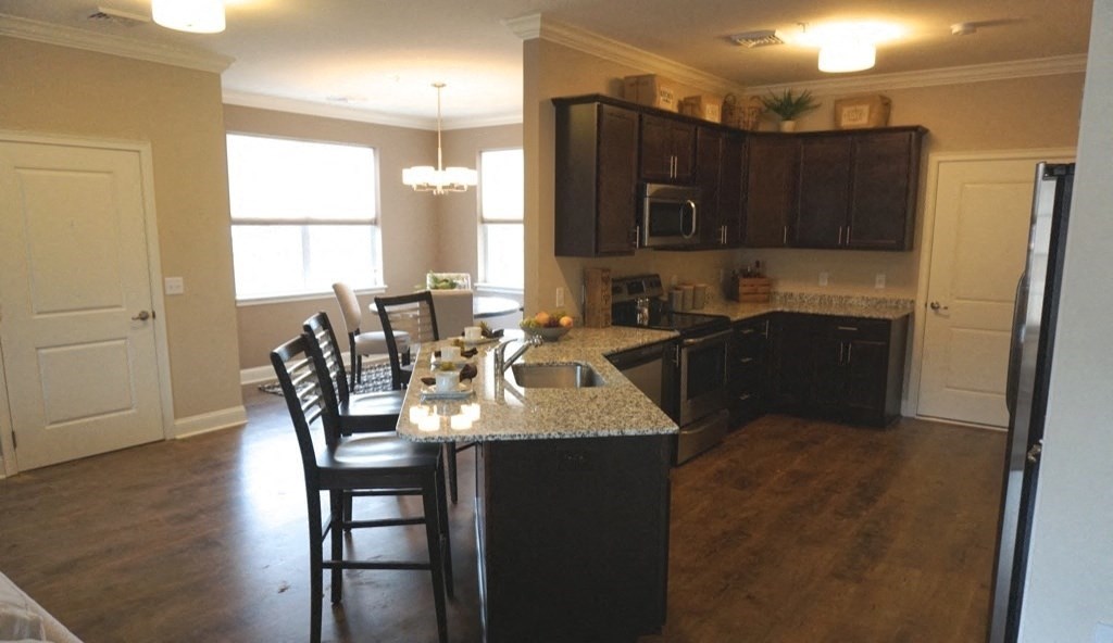 a kitchen with a island and a table with chairs