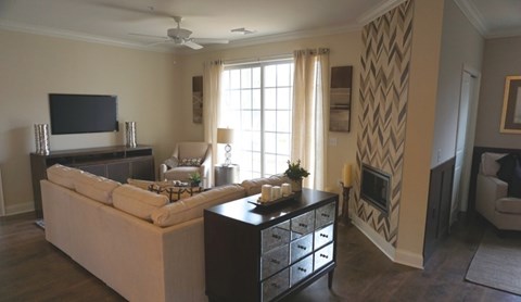 A living room with a white couch and a television.