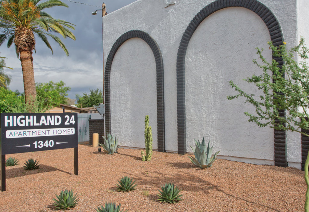 a building with three arches and a sign for highland 24 apartment homes