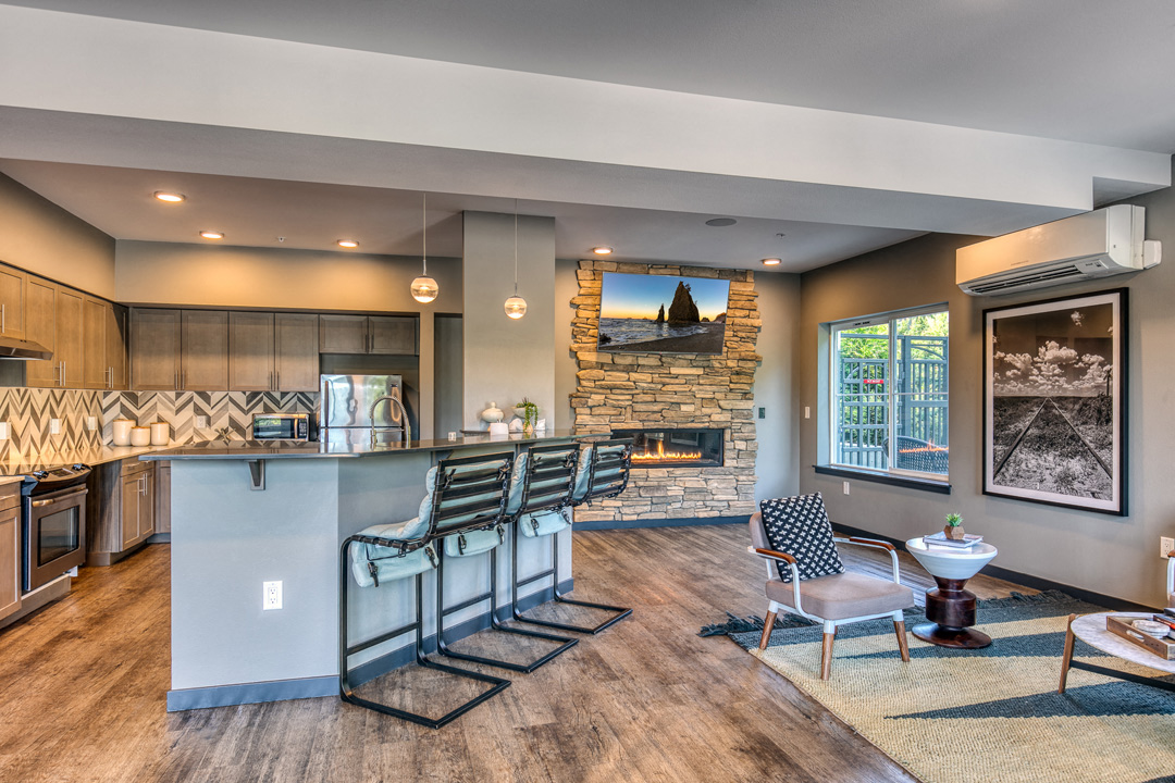 a kitchen and living room with a bar and a fireplace