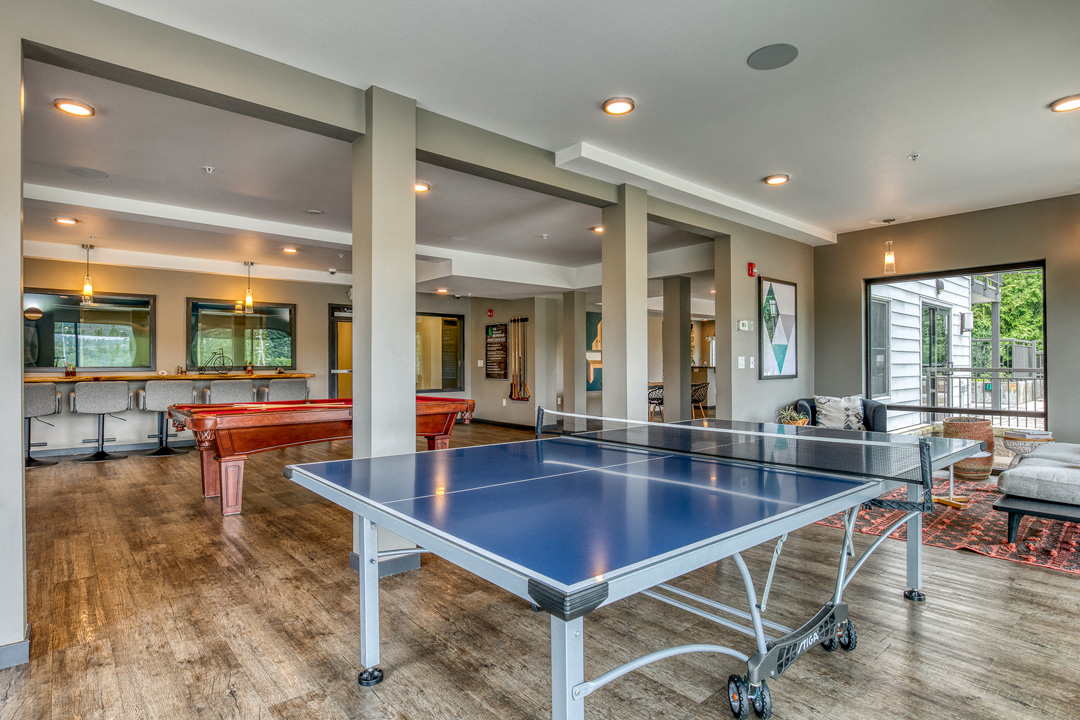 a game room with a ping pong table and a pool table