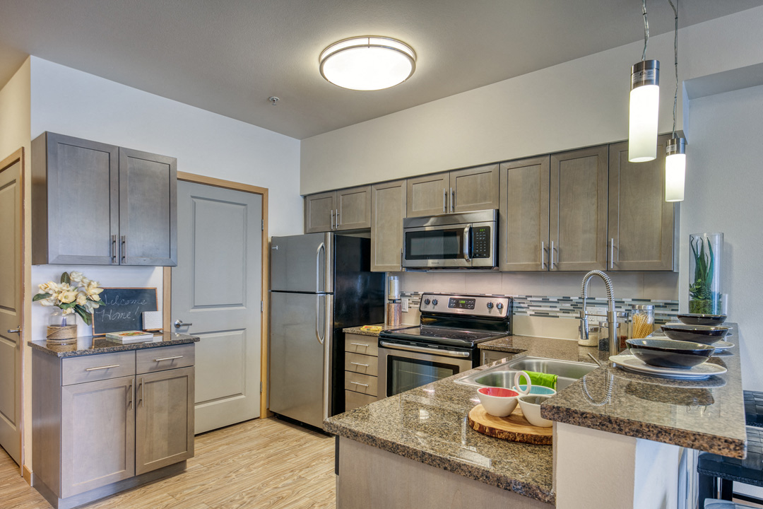 a kitchen with stainless steel appliances and granite counter tops