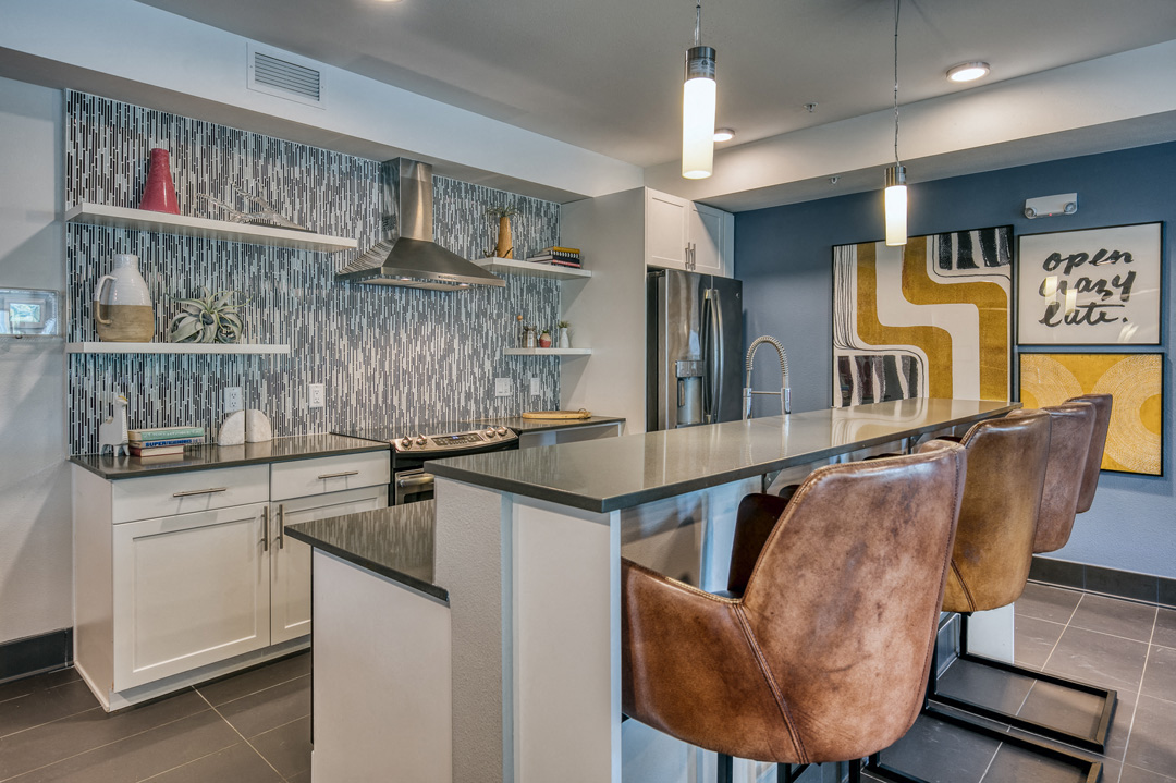 a kitchen with bar stools and a counter top