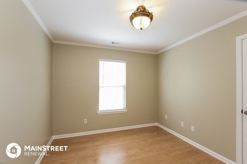 the interior of an empty room with wooden floors and a window