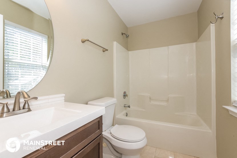 a bathroom with a sink toilet and a bath tub