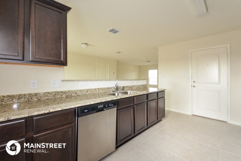a kitchen with a granite counter top and stainless steel appliances
