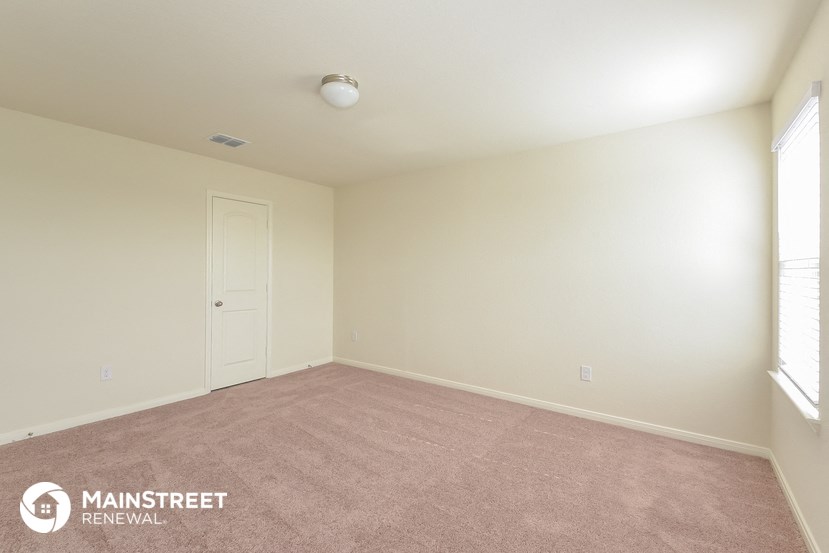 a room with a carpeted floor and a white door