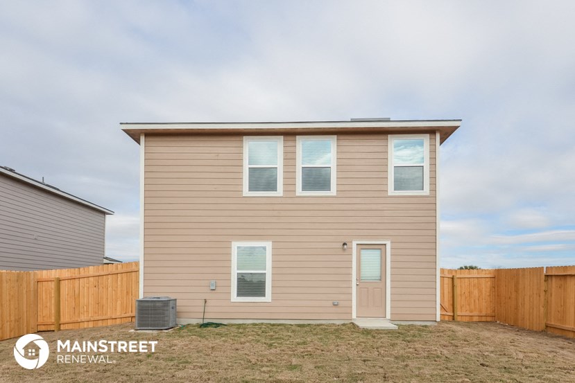 the exterior of a house with a wooden fence