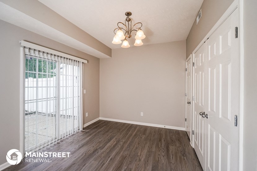 the living room of a new home with a large door to the patio
