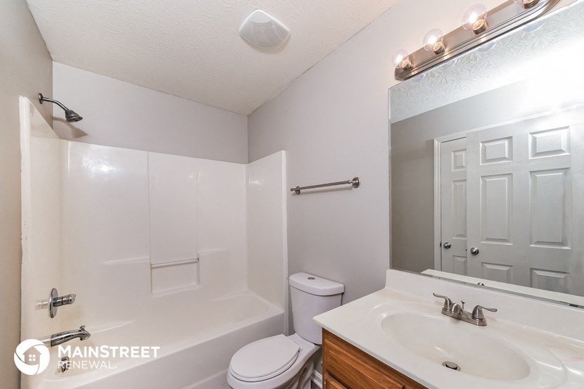 a bathroom with a sink and a toilet and a mirror