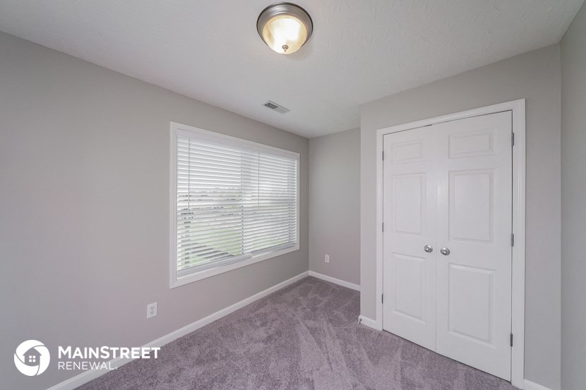 the upstairs bedroom has a door to the closet and a window