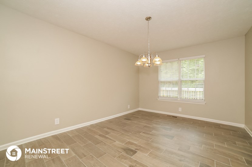 the spacious dining room with tile flooring and a window