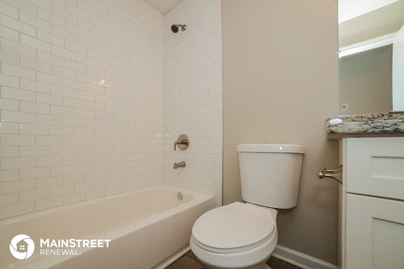 a bathroom with a tub and a toilet and a sink