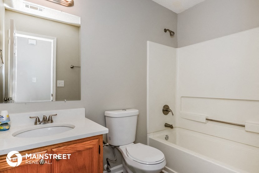 a bathroom with a sink toilet and a bath tub