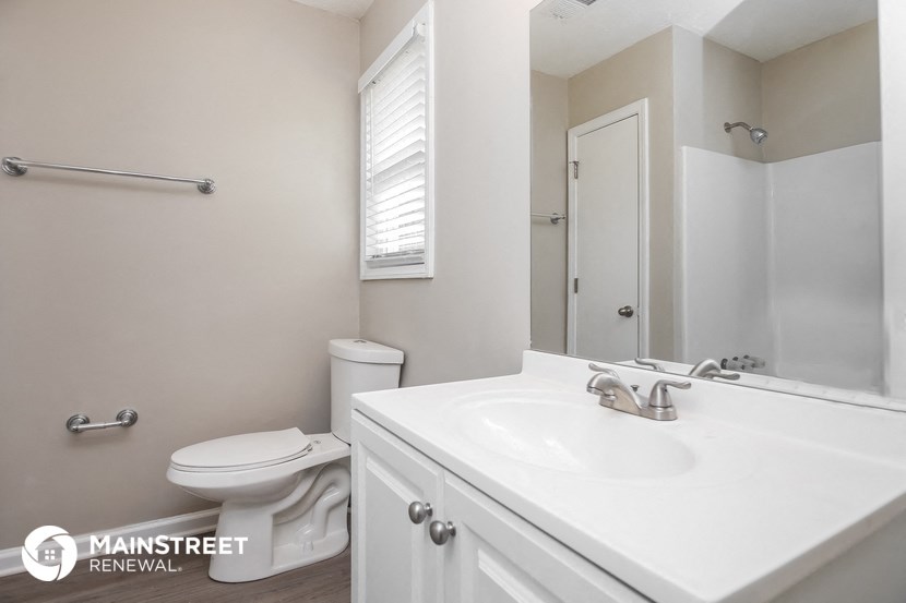 a bathroom with a sink and a toilet and a mirror