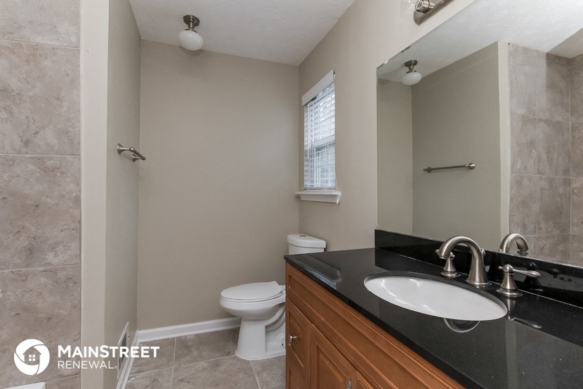 a bathroom with a sink and a toilet and a mirror