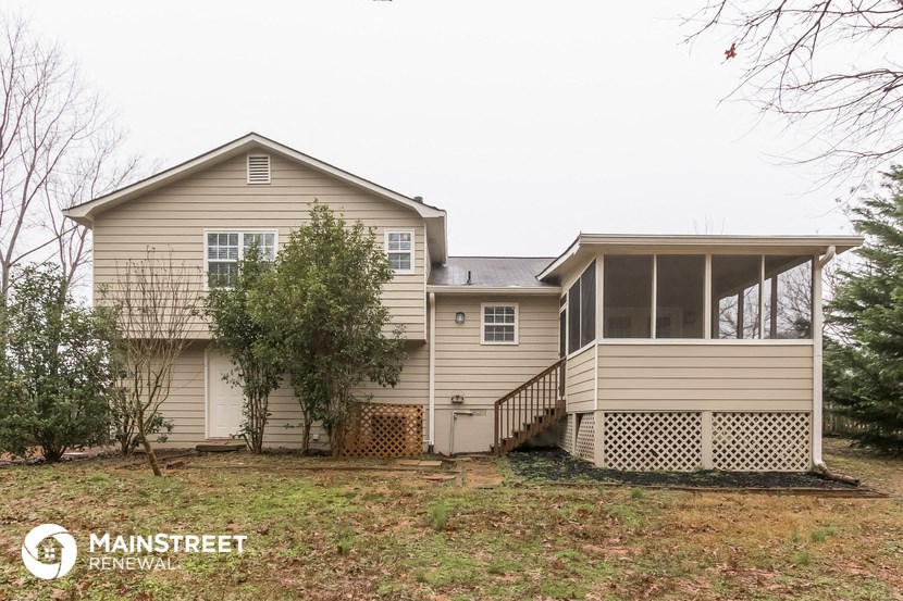 the front of a house with a yard and a deck