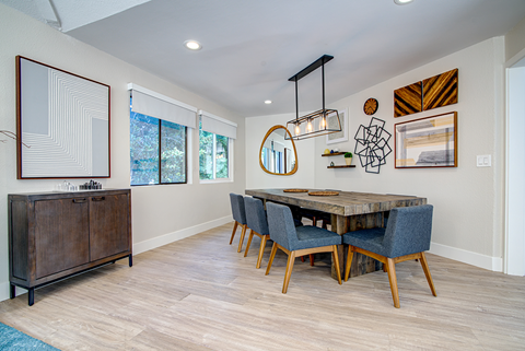 A dining room with a wooden table and chairs.