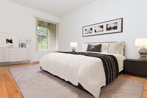 a bedroom with a bed and a rug