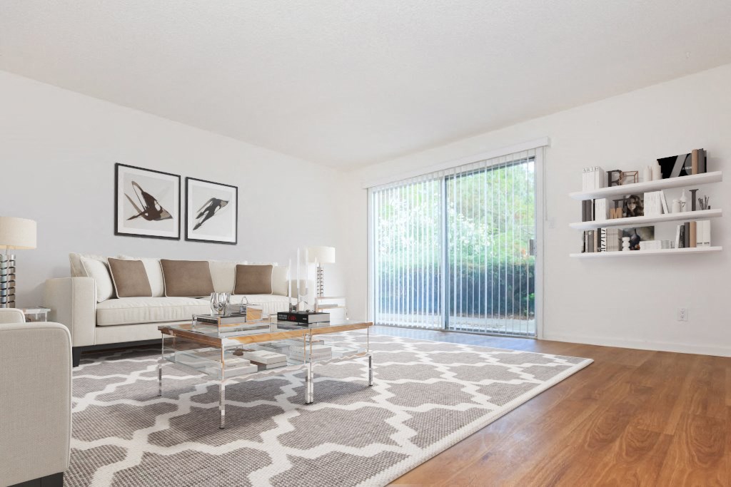 a living room with a couch and a table and a sliding glass door