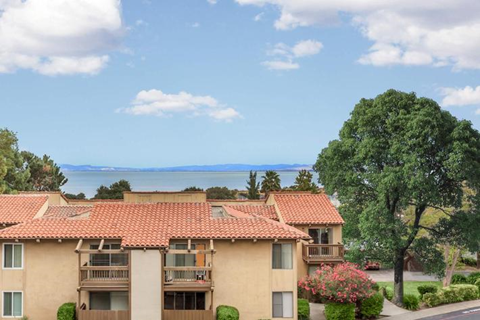 an apartment building with a view of the water