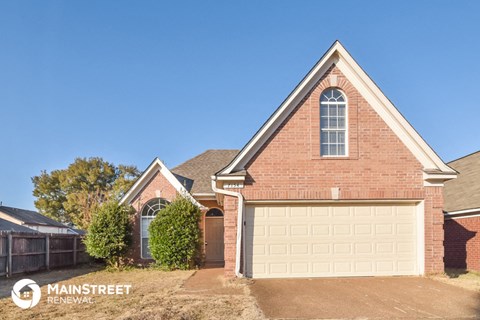 a garage door on a brick house with a clear blue sky