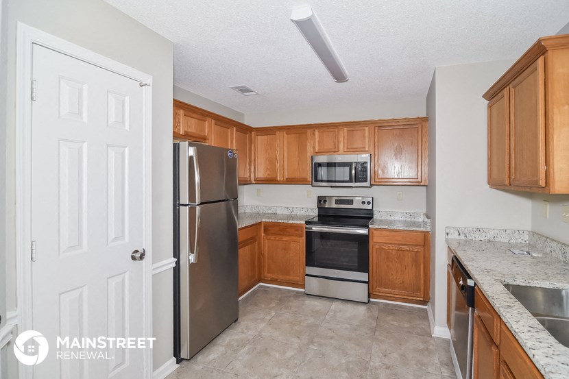 a kitchen with wooden cabinets and stainless steel appliances