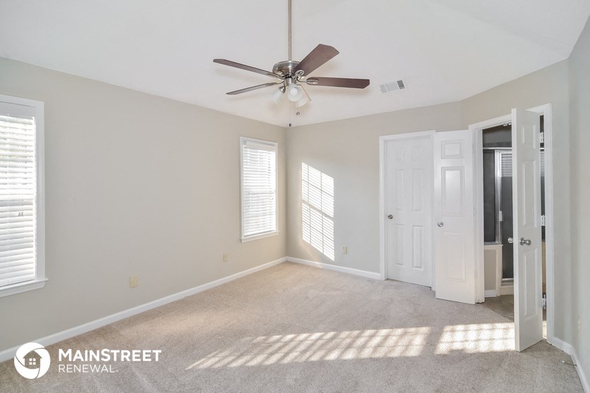 the master bedroom is spacious and has a ceiling fan