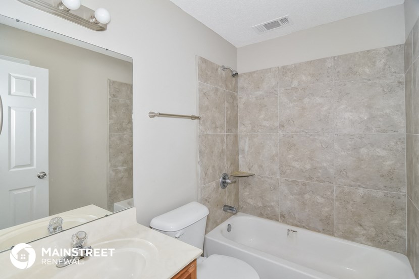 a bathroom with a tub and a sink and a toilet