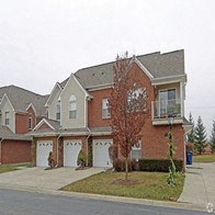 a large brick house with white garage doors