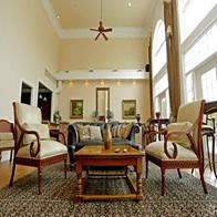 a living room filled with furniture and a ceiling fan