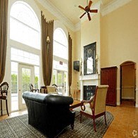 a living room with a black couch and a large window