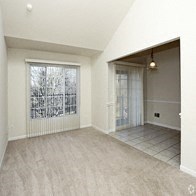 an empty living room with a sliding glass door