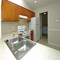 a kitchen with a sink a stove and a refrigerator