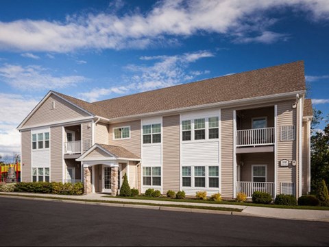 a large apartment building with a street in front of it