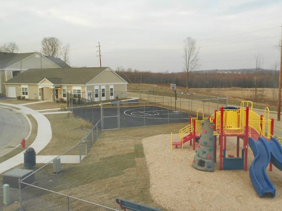 a playground at a park in front of a building