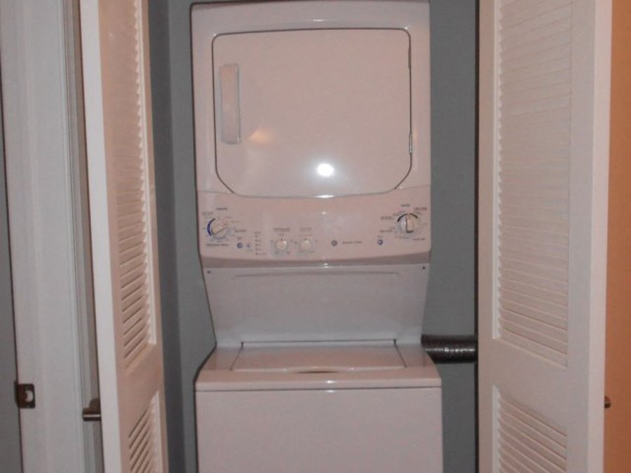 a white washer and dryer in a closet
