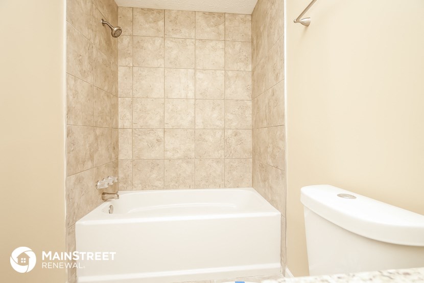 a small bathroom with a tub and a toilet