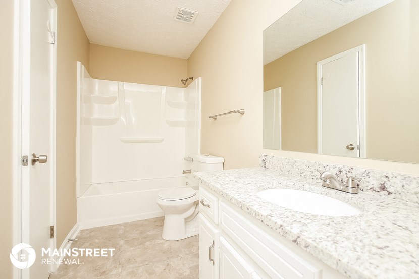 a bathroom with a sink and a toilet and a shower