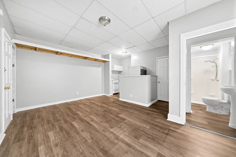 the living room and dining room of a renovated house with wood flooring