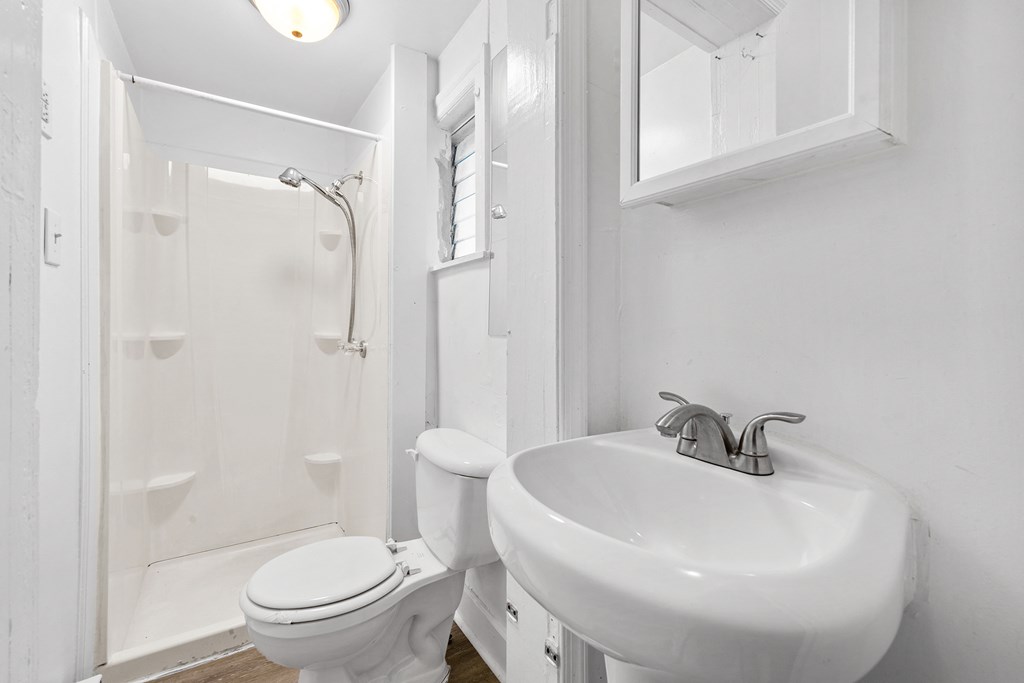 a small bathroom with a sink toilet and shower