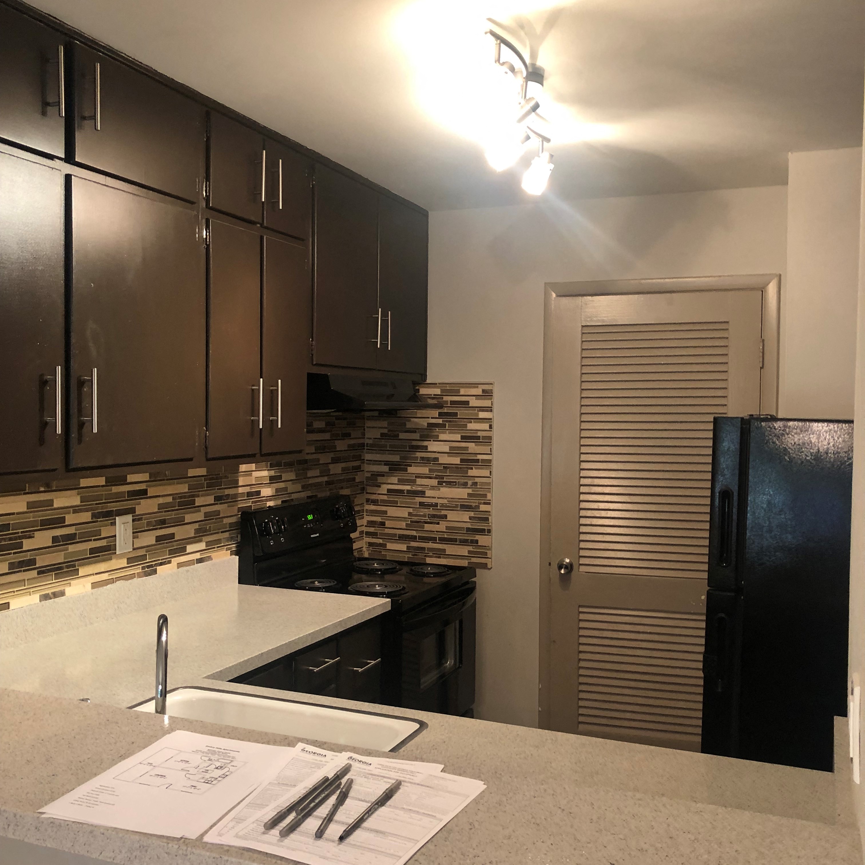 a kitchen with a counter top and a refrigerator