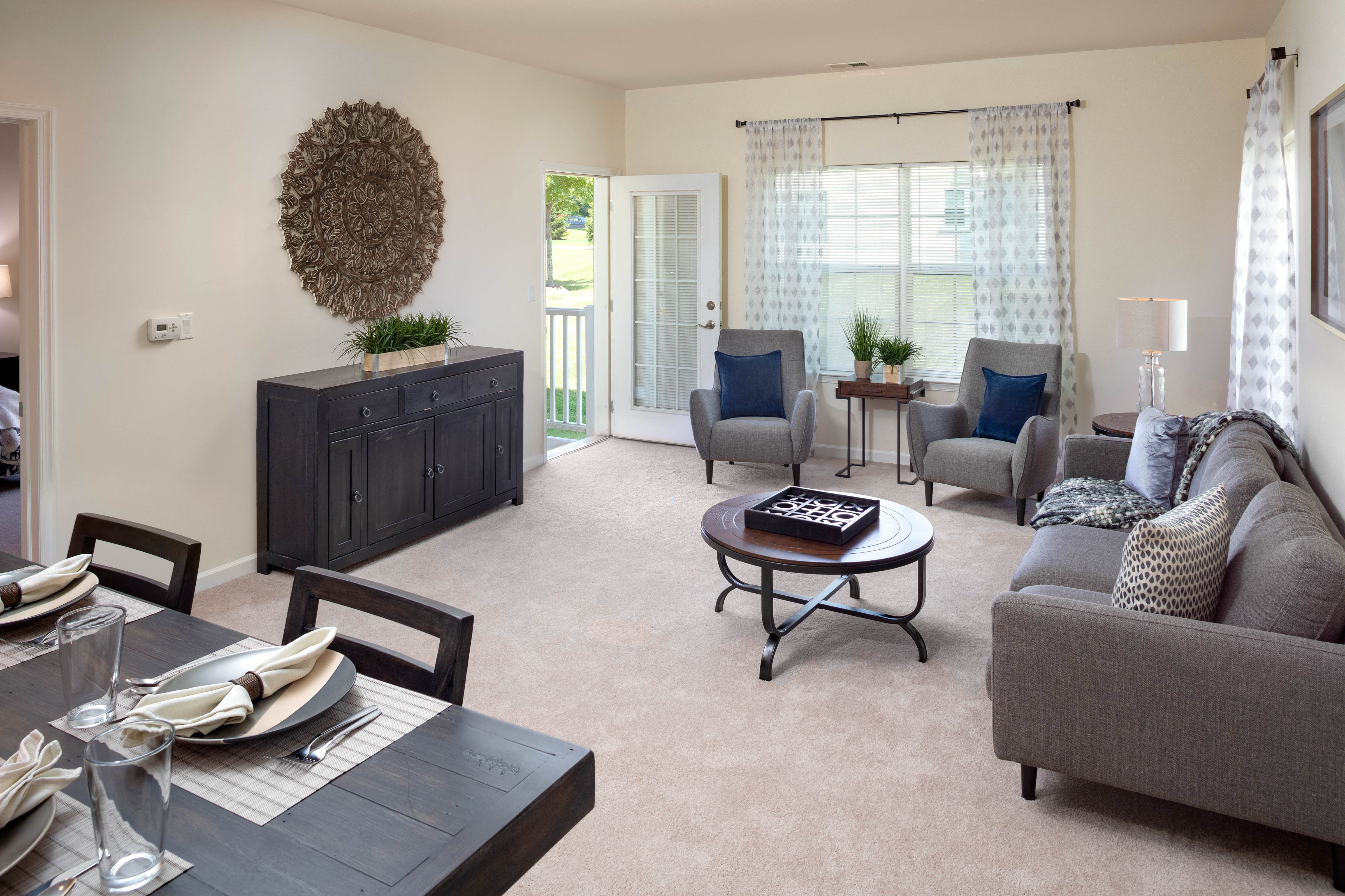 a living room with a couch and chairs and a table