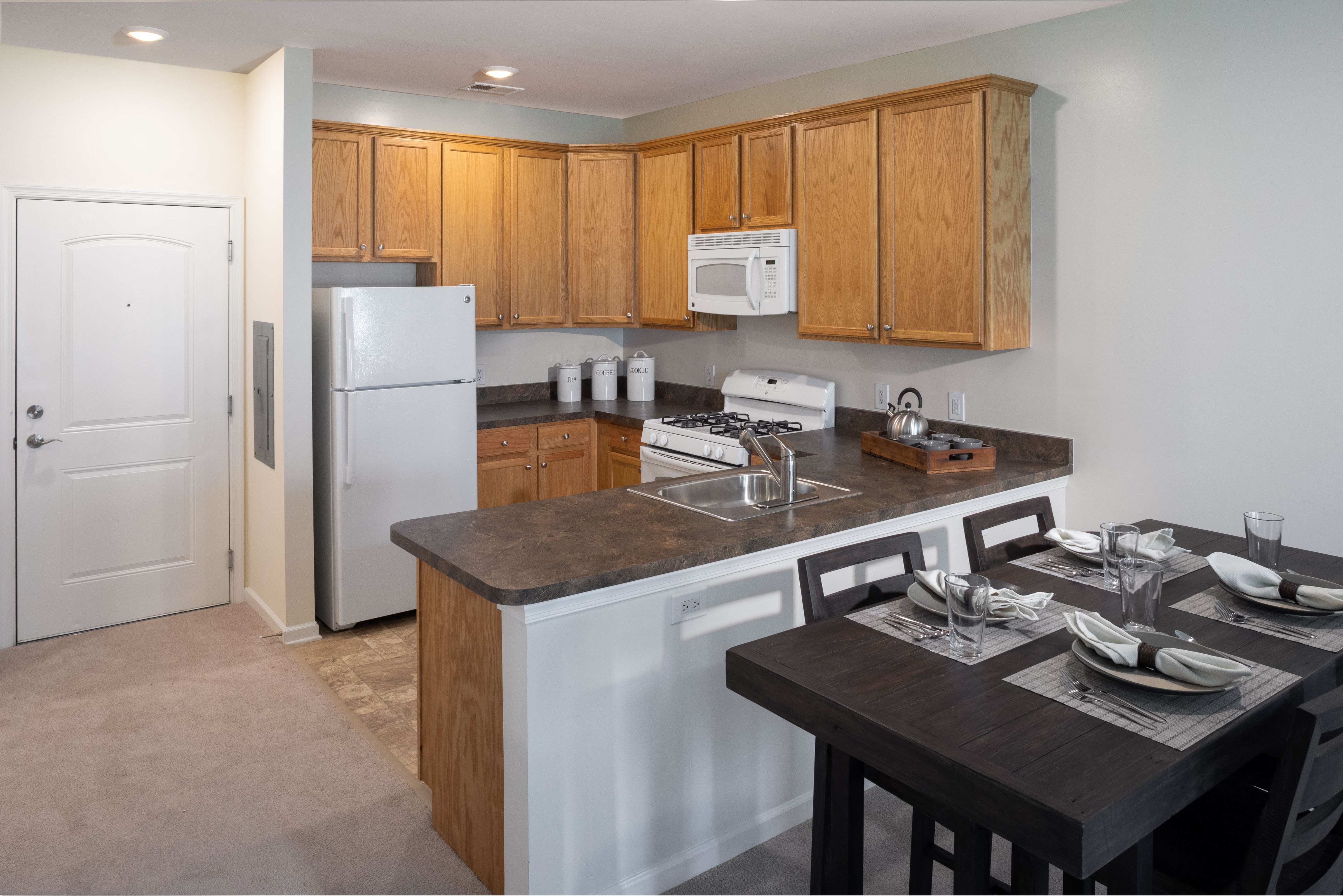 a kitchen with an island and a dining table