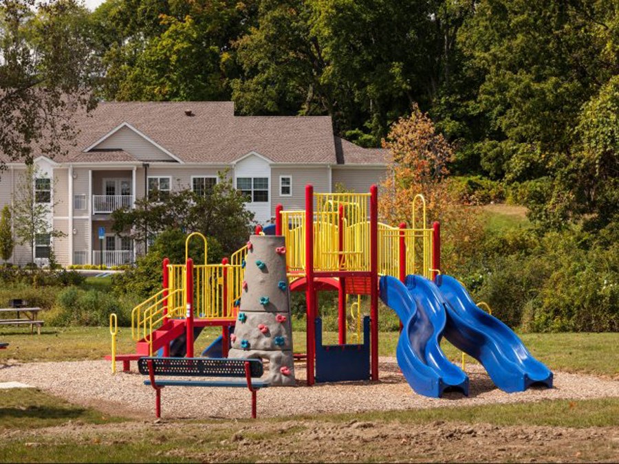 a playground in a park in front of a house