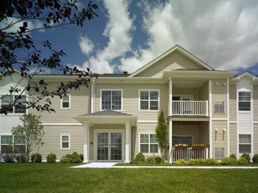 a large house with a porch and a lawn