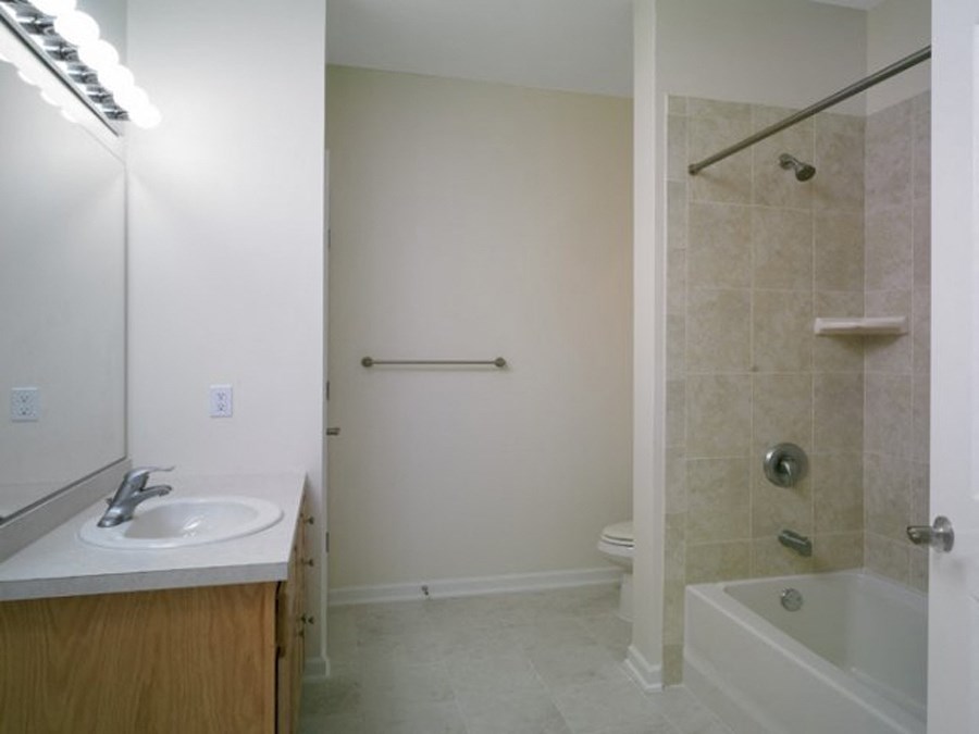 a bathroom with a sink and a shower and a toilet