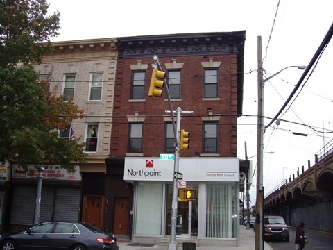 an old brick building on a street corner with a traffic light